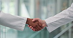 Doctor, people or meeting with handshake for healthcare deal or agreement in hospital. Closeup, health workers or employees shaking hands with partnership for recruit or medical onboarding in clinic