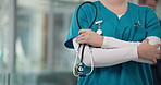 Hands, arms crossed and nurse with stethoscope in hospital for heart health, professional or pride. Woman, medical worker and tools for cardiology, confidence and equipment for wellness in clinic