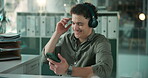 Phone, dancing or man in office with headphones, podcast or audio choice in break. Happiness, flare and corporate employee in agency with tech, radio streaming and music decision in workplace rest.