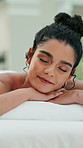 Relax, spa and woman on massage table with eyes closed, healing treatment or muscle therapy in wellness center. Peace, dreaming or client in resort on bed, serenity or stress relief at luxury retreat
