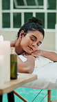 Relax, spa and woman on massage table by pool, healing treatment or muscle therapy in wellness center. Peace, dreaming or client in swim area on bed, serenity or stress relief at luxury resort.