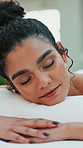 Relax, spa and woman on massage table with resting, healing treatment or muscle therapy in wellness center. Peace, dreaming or client in resort on bed, serenity or stress relief at luxury retreat.