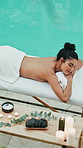 Above, spa and woman on massage table with pool, relaxing treatment or muscle therapy in wellness center. Peace, dreaming or client in swim area on bed, serenity or stress relief at luxury resort.