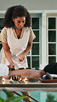 Spa, massage and woman with hot stone, luxury and treatment for holistic benefits and stress relief. Hospitality, masseuse and person on holiday for peace, above and comfortable at wellness resort