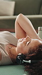 Mindfulness, streaming and woman with headphones on floor, music or listen to audio on break in home. Calm, person and tech for sound, relax and zen with playlist on mat, awareness and song on radio