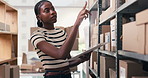 Boxes, clipboard and counting with black woman in storage depot for inventory or logistics management. Shelves, stock and supply chain with African person in office for delivery or shipping schedule