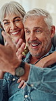 Senior couple, selfie and hug on couch with smile, funny face and connection for bonding in lounge. Elderly man, woman and happy with photography, profile picture or social media post at apartment