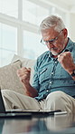 Mature man, laptop and fist pump with phone call, success and remote work from home for deal on sofa. Person, freelance writer and celebration with applause, smartphone or goals with project funding