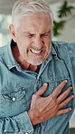 Senior man, walking and panic with chest pain for heart attack, hypertension or angina in home. Elderly, male person or pensioner with sore ache, anxiety or discomfort for artery shock or stroke