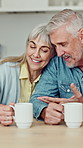 Talk, coffee and senior couple in kitchen in home for conversation, bonding or connection together. Happy, love and elderly man with woman for drinking warm beverage in morning with support in house.