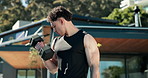Bodybuilding, outdoor and man with dumbbells, fitness and training for muscle development or health. Bodybuilder, wellness and person with weights for exercise at home, strength and metabolism boost