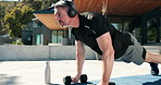 Outdoor, push up and man with dumbells, headphones and listening to music, bodybuilding and exercise. Streaming, audio and mature person with equipment for muscle strength, home and fitness with tech