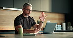 Video call, online and man with laptop in kitchen, virtual assistant or communication with earphones. Talking, mature person and financial review with client on website, digital consultation and home
