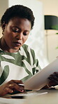 Clipboard, calculator and finance with black woman in home for budget report, banking statement and audit review. Mortgage payment, savings account and invoice bills with person in apartment for tax