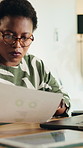 Black woman, laptop and reading document at house for accounting, finance report and data analysis. Female person, remote work and paperwork with financial stats, kpi performance and asset management
