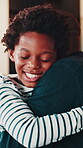 Black family, father and son with hug in home for connection, bonding together or affection. Parent, happy child or embrace with gratitude in living room for compassion, support or trust development.