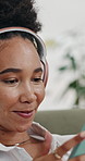 Happy woman, headphones or listening with phone for music, entertainment or audio streaming in home. Female person, relax and podcast with smile, tune or comfort for sound, playlist or songs in house
