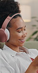 Happy woman, headphones and listening with music for entertainment or audio streaming in home. Female person, relax and podcast with smile, tune or comfort for sound app, playlist or songs in house