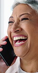 Laughing, phone call and reaction with mature woman in home for communication or humor. Conversation, funny and mobile with happy person in apartment living room for comedy, feedback or joke