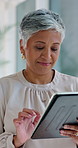 Employee, research and woman with tablet in office, thinking or checking property listing on website. Scroll, online and mature person with tech for competition analysis, happy and real estate agent
