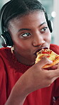 Lunch break, pizza and black woman with headset in call center, customer service or eating fast food. Hungry, work pause and virtual assistance with laptop for tech support, takeaway meal or hotline