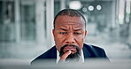 Black man, thinking and reading in office with computer for problem solving, finance report and decision. Mature person, insight and research in workplace with desktop, financial solution and bokeh.