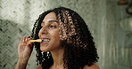 African woman, brushing teeth and toothbrush in bathroom for fresh breath, dental care and hygiene. Female person, cleaning and mouth to remove plaque, prevent gingivitis and morning routine at house