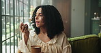 Woman, spoon and eating ice cream in living room for sweet treat craving, pudding and snack in home. Female person, gelato or frozen yogurt in house for dessert, comfort food and hunger satisfaction.