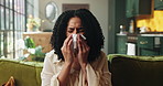 Woman, sneeze or blowing nose on couch with tissue for influenza, health problem and virus symptoms. Sick person, allergies or illness in home with toilet paper for hayfever, cold or sinus infection.