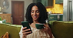 Coffee, phone and woman on sofa in home with networking, communication or social media on mobile app. Happy, cellphone and female person drinking warm beverage with texting, chatting or contact.