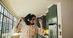 Headphones, dancing and happy woman in kitchen with music, streaming music playlist and online radio song. Audio tech, energy and person in home with movement for rhythm, playlist and track listening