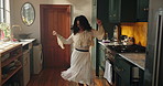Happy, dancing and woman in kitchen in home with music for rhythm on weekend break with entertainment. Energy, goofy and female person with listening to playlist for groove with fun in apartment.