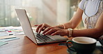 Hands, laptop and typing with designer person at table in home for remote work as entrepreneur. Computer, design and report with freelance employee in apartment for startup planning or research