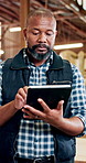 Black man, carpenter or inspection with tablet in workshop for wood production, stock or inventory. Male person, artisan or storage with technology, checklist or timber for carpentry business startup