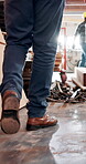 Carpentry, walking and legs of man in workshop, renovation project and production development. Woodworking, manufacturing and carpenter team together for construction, restoration and maintenance