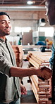 Businessman, carpenter and handshake with group in woodshop for agreement, partnership or success. Male person, colleagues or woodworker shaking hands with smile for DIY project or furniture business
