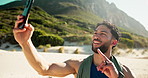 Fitness, man and selfie with peace sign at beach for exercise blog, social media post or memory. Workout influencer, person and emoji with photography on seashore for profile picture or cardio update