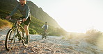 Exercise, morning and people on bicycle in nature for sports, cardio workout and challenge outdoor. Countryside, travel and cyclists on mountain bike for adventure, journey and wellness on trail