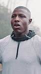 Fitness, man and tired with breathing in rain outdoor for workout challenge, running fatigue or rest. Athlete, black person or exhausted in cold weather for exercise recovery, intense cardio or break