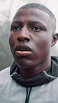 Athlete, man and tired with breathing in rain outdoor for fitness challenge, cardio fatigue or rest. Runner, black person and exhausted in cold weather for exercise recovery, intense workout or break