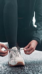 Person, hands and tying with laces on road for workout preparation, outdoor exercise or start. Closeup, active or runner getting ready with tie, sneaker or shoe for fitness or physical activity