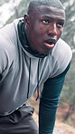 Runner, man and breathing outdoor in rain for workout challenge, running burnout or overworked. Break, black person and exhausted in cold weather for exercise recovery, intense cardio and endurance