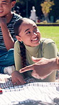 Girl, students and laugh on lawn, chat and gossip with funny story for group at college campus. People, friends and relax on blanket, talk and bonding on break, scholarship or education at university