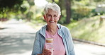 Senior, happy woman and face with water bottle for fitness, hydration or health in neighborhood. Portrait, elderly or female person with smile, mineral liquid or aqua beverage for wellness on road