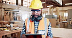 Carpenter, man and typing in workshop with tablet, building project info and manufacturing research. Mature black person, PPE and tech in factory for woodwork plan, furniture production and repair.