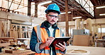 Man, carpenter and tablet at factory, review or check notification with furniture manufacturing. Person, technician and scroll notes for woodwork project, helmet or design application at workshop
