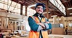 Man, face and carpenter with arms crossed at factory, smile or safety goggles for furniture production. Person, happy and portrait with ppe glasses, excited or confident for manufacturing in workshop