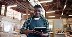 Man, carpenter and tablet at warehouse, review or check notification with furniture manufacturing. Person, technician and scroll notes for woodwork project, helmet or design application at workshop