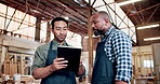 Woodwork, men and talking with tablet in workshop for order update, inventory and design review. Manufacturing, carpenter team and discussion with tech in warehouse for furniture remodeling and below