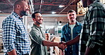 Handshake, meeting and carpenter with people in warehouse for furniture deal, woodworking or agreement. Manufacturing partner, shaking hands and project contract with employees for timber production